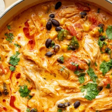 Bowl of flavorful Chicken Enchilada Soup topped with cheese and cilantro