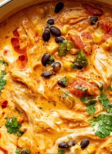 Bowl of flavorful Chicken Enchilada Soup topped with cheese and cilantro