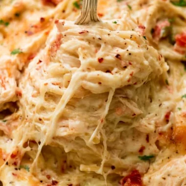 Cheesy Chicken Spaghetti Casserole served in a baking dish with garnishes.