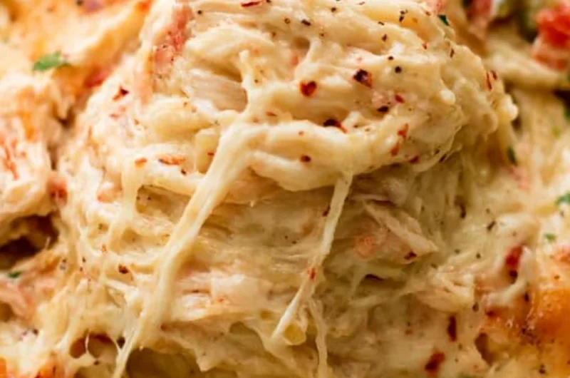 Cheesy Chicken Spaghetti Casserole served in a baking dish with garnishes.