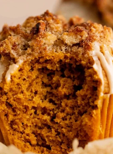 Freshly baked gluten free pumpkin muffins on a rustic table.