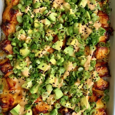 Healthy salmon sushi bake topped with fresh ingredients and herbs