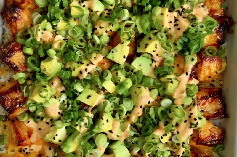 Healthy salmon sushi bake topped with fresh ingredients and herbs